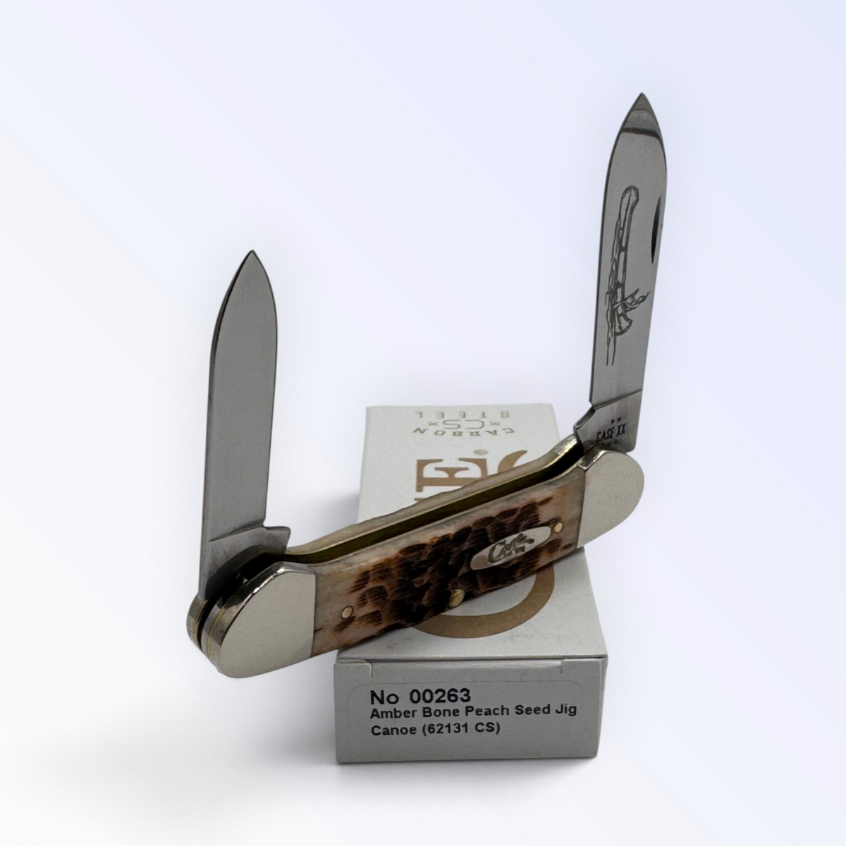 Pigeon Roost Knives Case XX Canoe pocket knife with amber bone peach seed jig handles and dual carbon steel blades.
