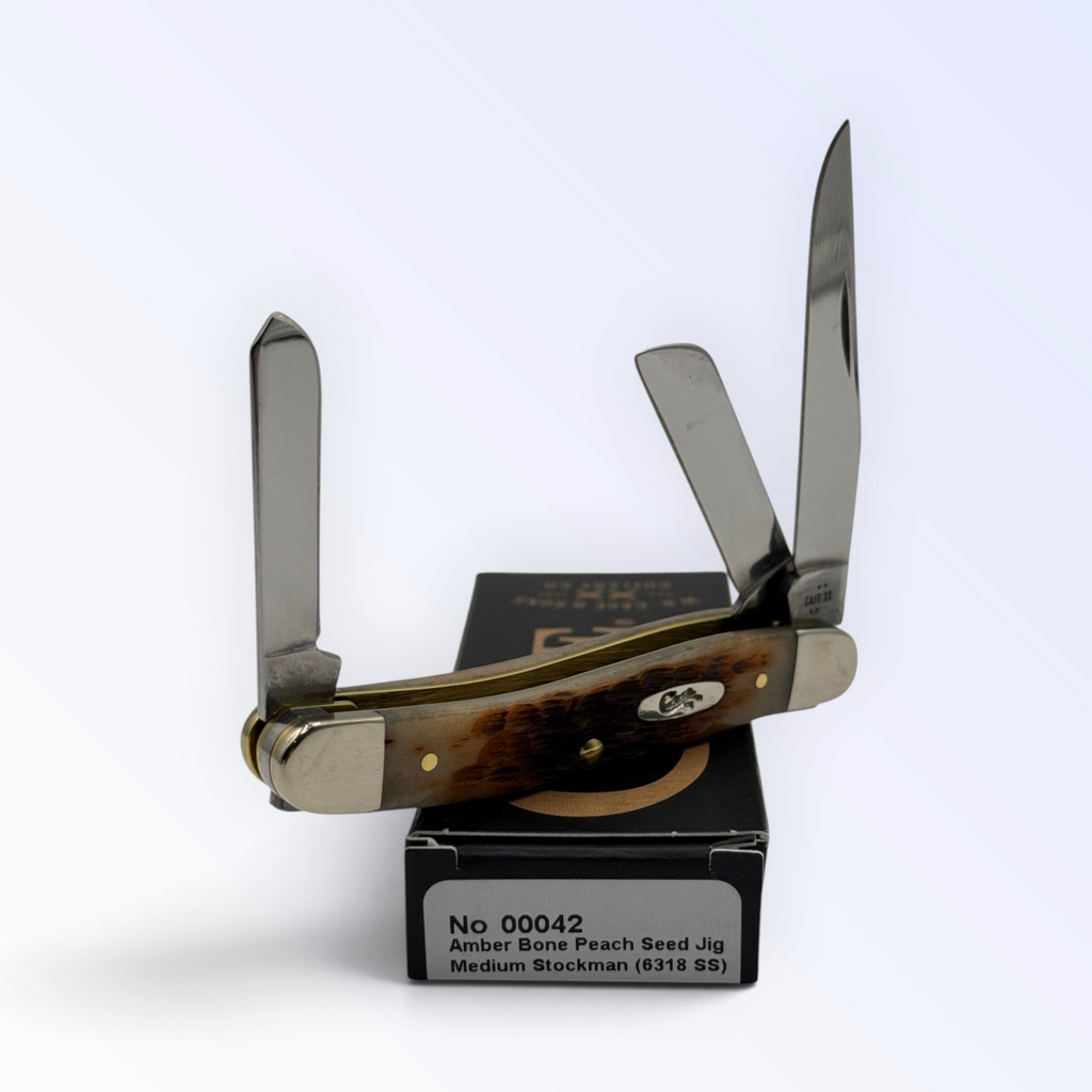 Pigeon Roost Knives Case XX Medium Stockman pocket knife with peach seed jigged amber bone handle and three blades.