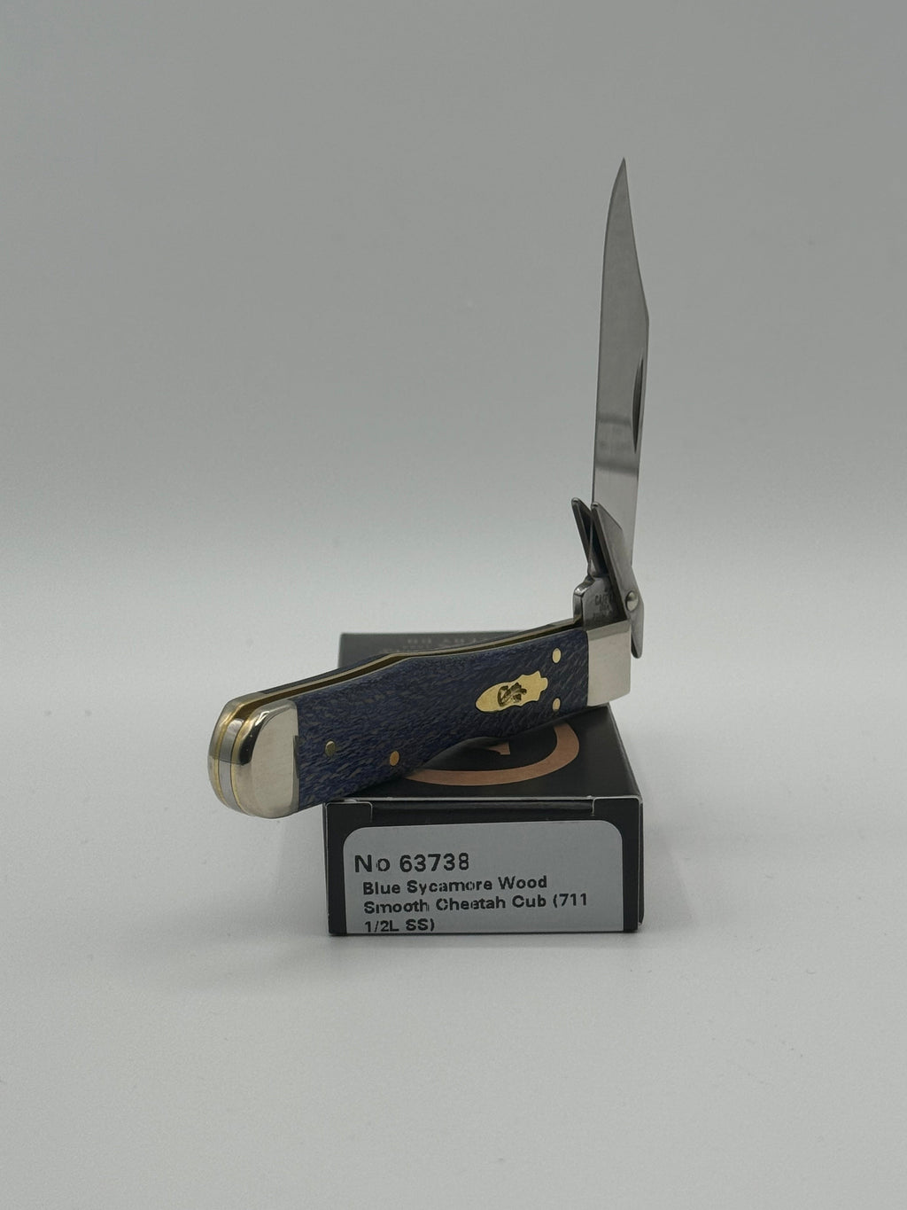 Pigeon Roost Knives Case XX Cheetah Cub pocket knife with blue sycamore wood handle and swing guard open on its box