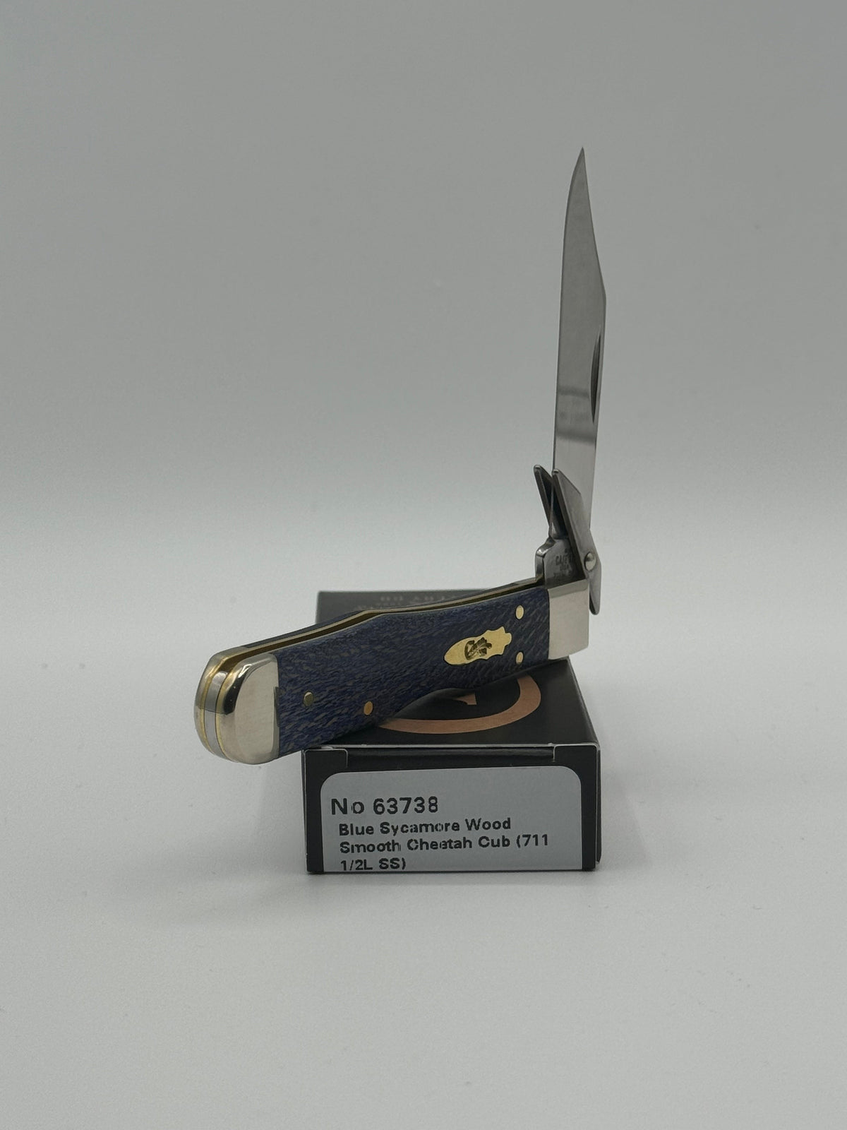 Pigeon Roost Knives Case XX Cheetah Cub pocket knife with blue sycamore wood handle and swing guard open on its box