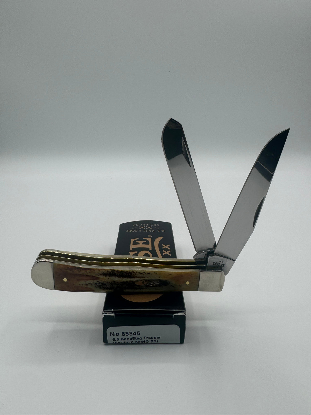 Pigeon Roost Knives Case XX 6.5 BoneStag Trapper pocket knife with open clip and spey blades on its original box.