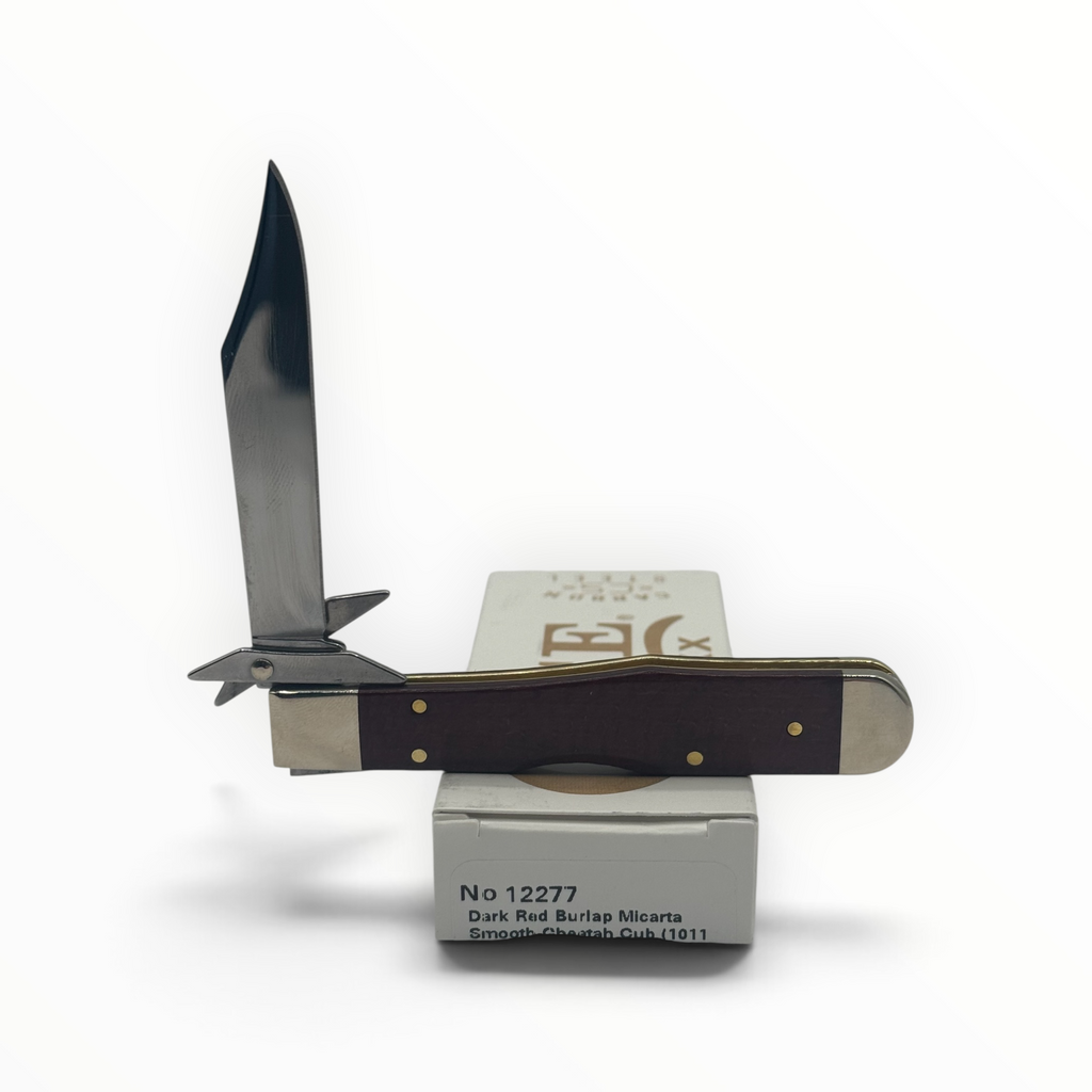Pigeon Roost Knives Case XX Cheetah Cub with dark red burlap Micarta handle, swing guard, and carbon steel blade.