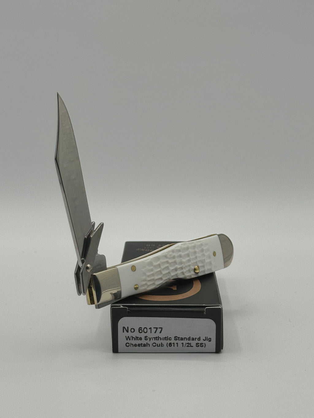 Pigeon Roost Knives Case XX Cheetah Cub pocket knife with white jigged synthetic handle and locking clip blade.