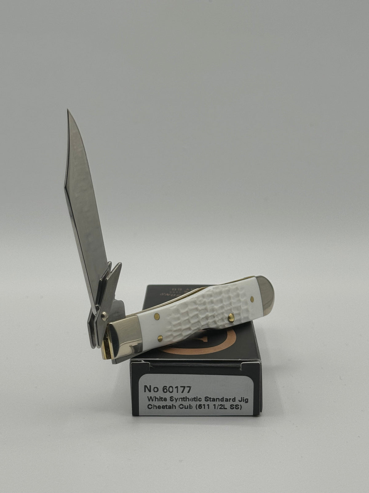 Pigeon Roost Knives Case XX Cheetah Cub pocket knife with white jigged synthetic handle and locking clip blade.