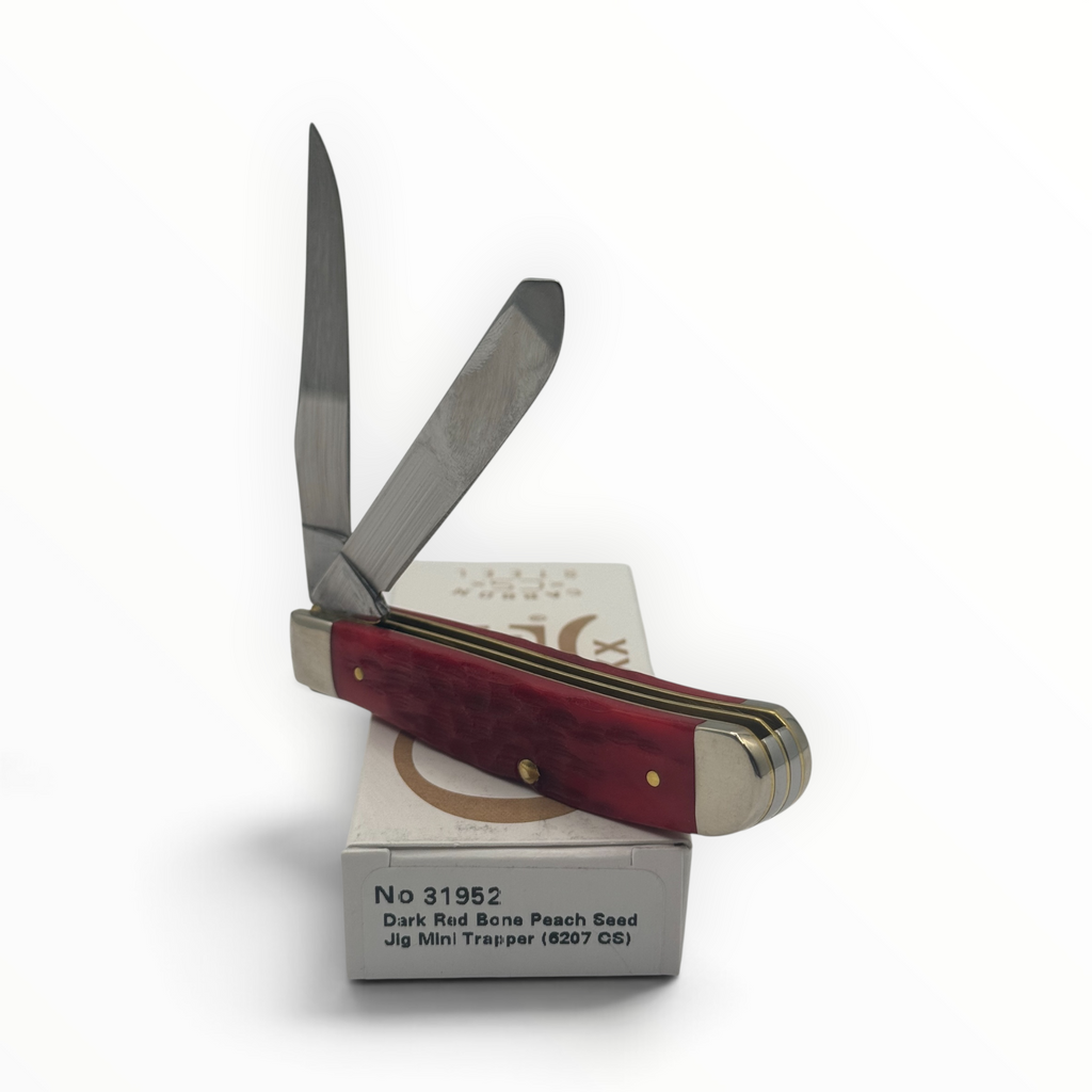 Pigeon Roost Knives Case XX Mini Trapper with dark red peach seed jigged bone handle and two carbon steel blades