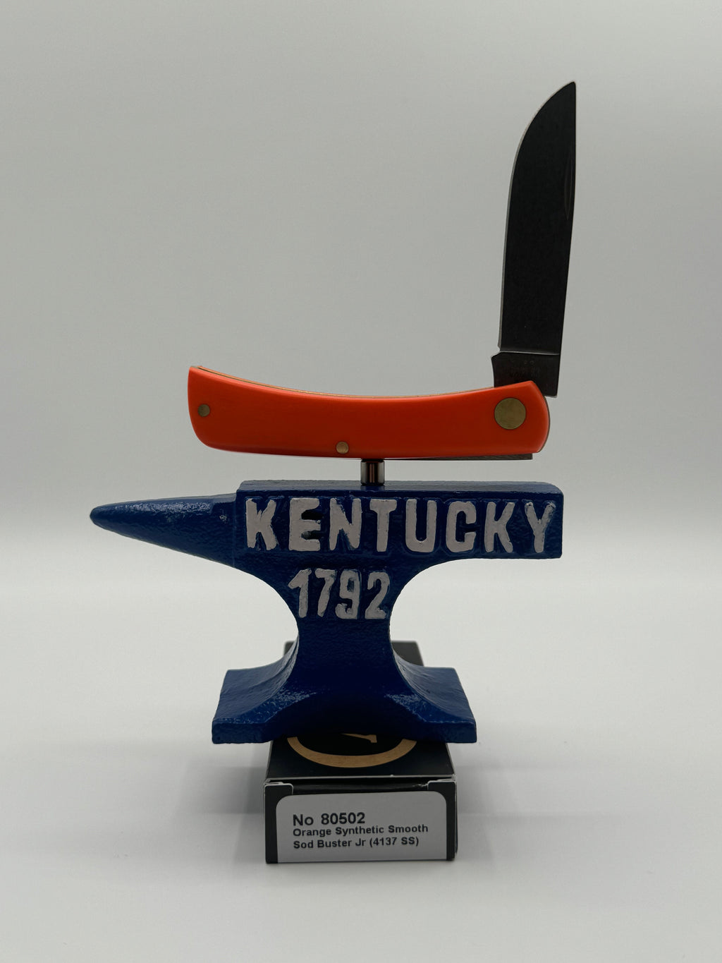 Pigeon Roost Knives Case XX Sod Buster Jr pocket knife with smooth orange synthetic handle balanced on a Kentucky anvil