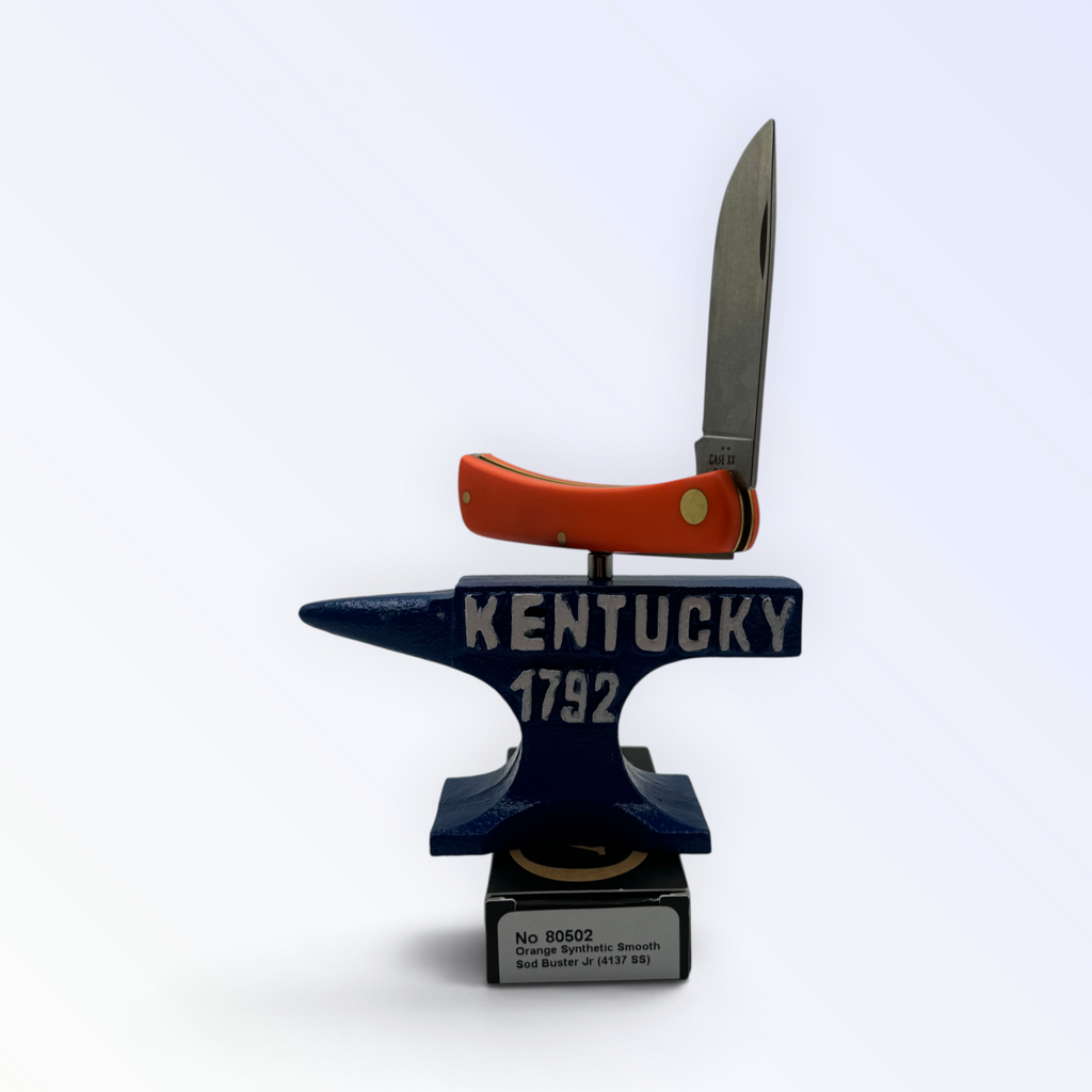Pigeon Roost Knives Case XX Sod Buster Jr pocket knife with a smooth orange synthetic handle on a Kentucky anvil stand