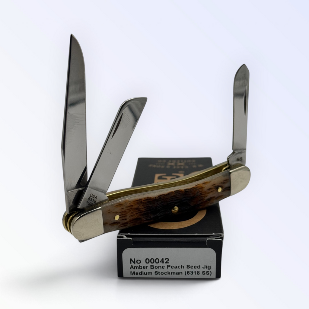 Pigeon Roost Knives Case XX Medium Stockman pocket knife with amber peach seed jigged bone handle and three steel blades