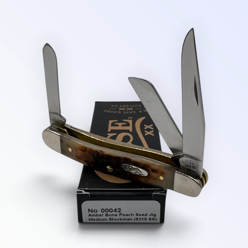 Pigeon Roost Knives Case XX Medium Stockman pocket knife with amber peach seed jigged bone handle and three blades.