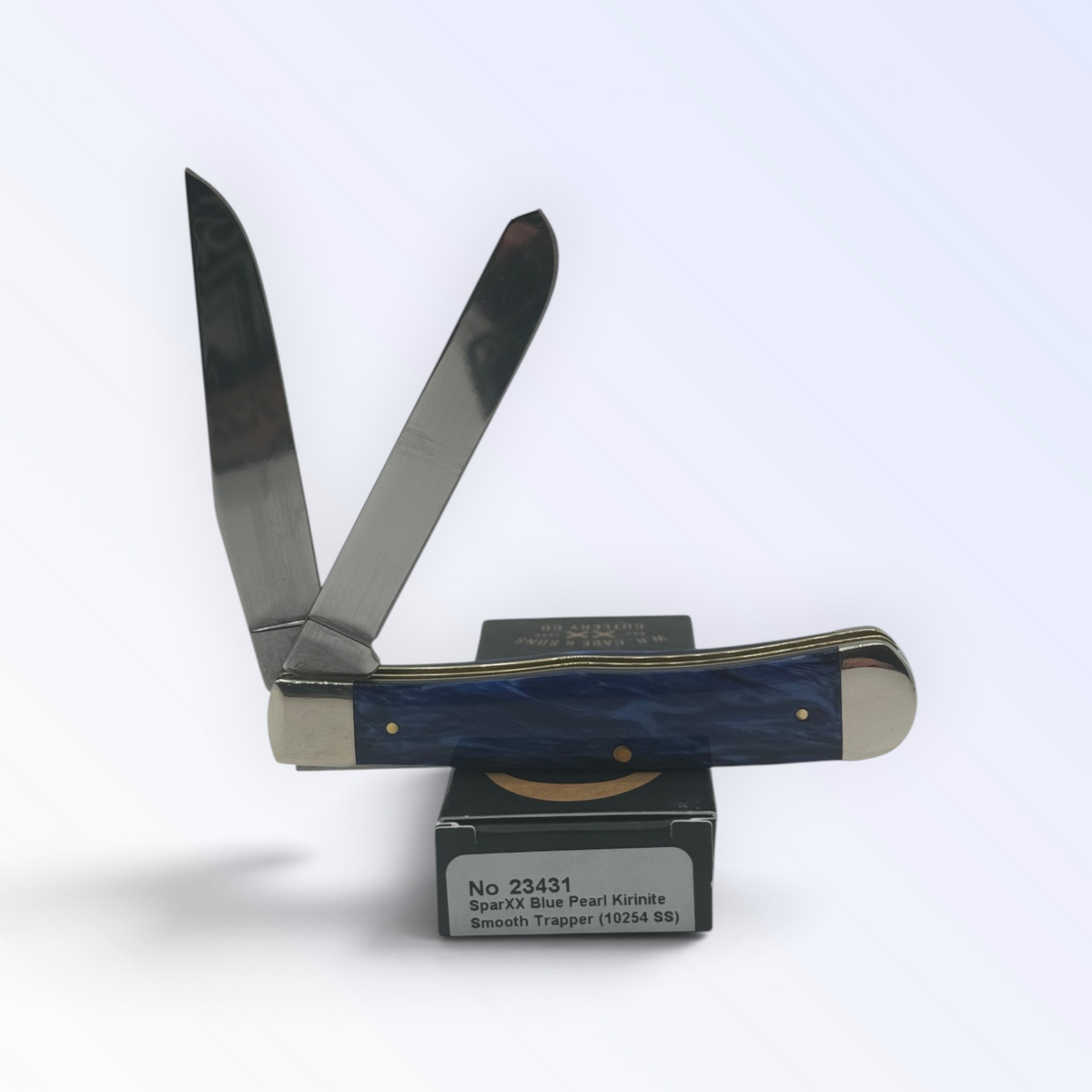 Blue Pearl Kirinite Trapper by Case XX (23431), close view of handle texture with blades open on box