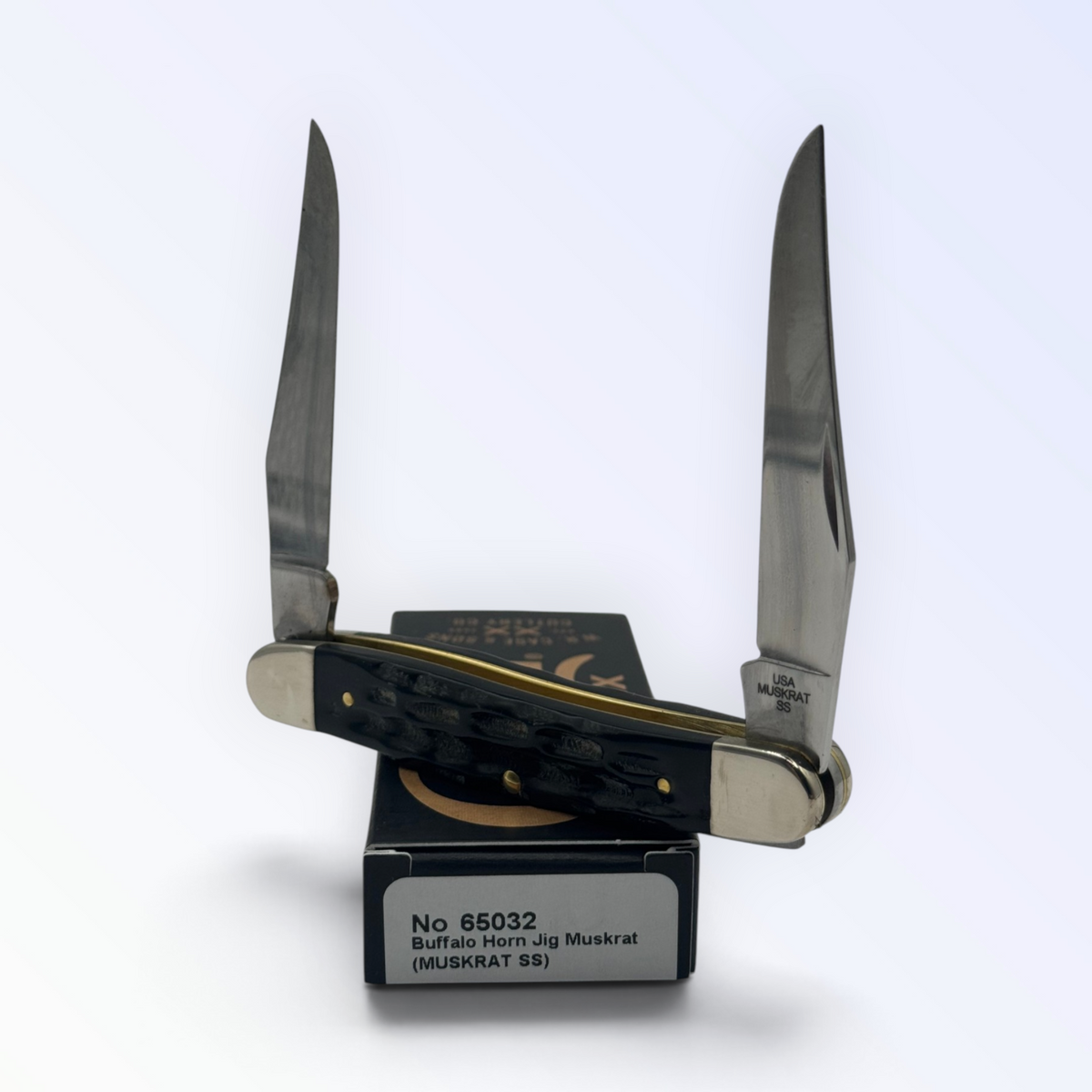 Catalog 65032 Case XX – Buffalo Horn Jig Muskrat — open blades resting on factory packaging