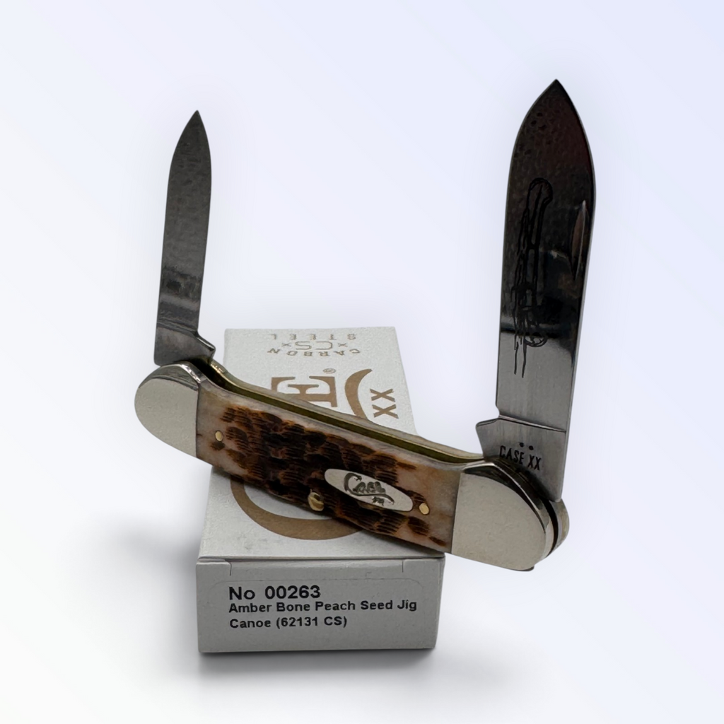 Pigeon Roost Knives Case XX Canoe pocket knife with amber bone peach seed jigged handle and dual carbon steel blades.