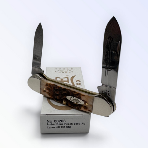 Pigeon Roost Knives Case XX Canoe pocket knife with amber bone peach seed jigged handle and dual carbon steel blades.