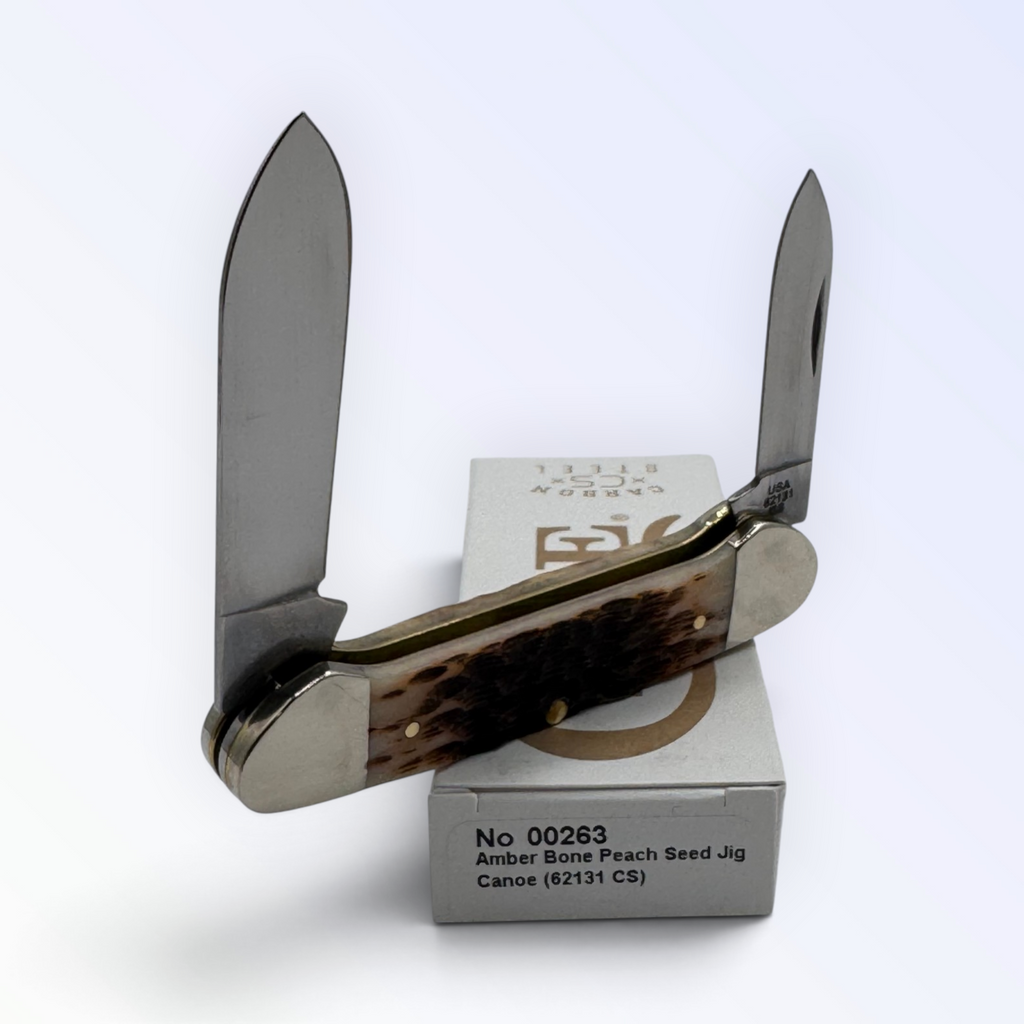 Pigeon Roost Knives Case XX Canoe pocket knife with amber bone peach seed jigged handle and dual carbon steel blades.