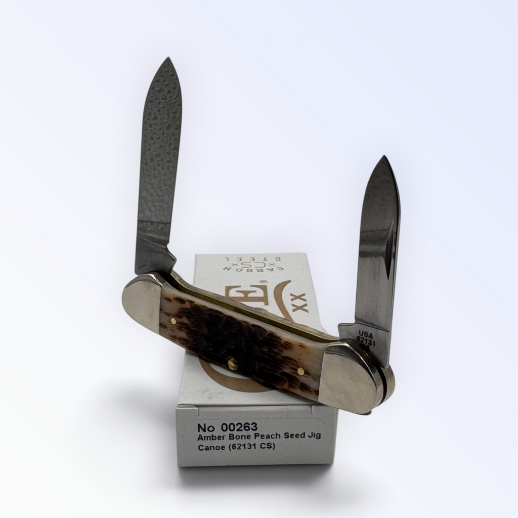 Pigeon Roost Knives Case XX Canoe pocket knife with amber peach seed jigged bone handles and dual carbon steel blades.