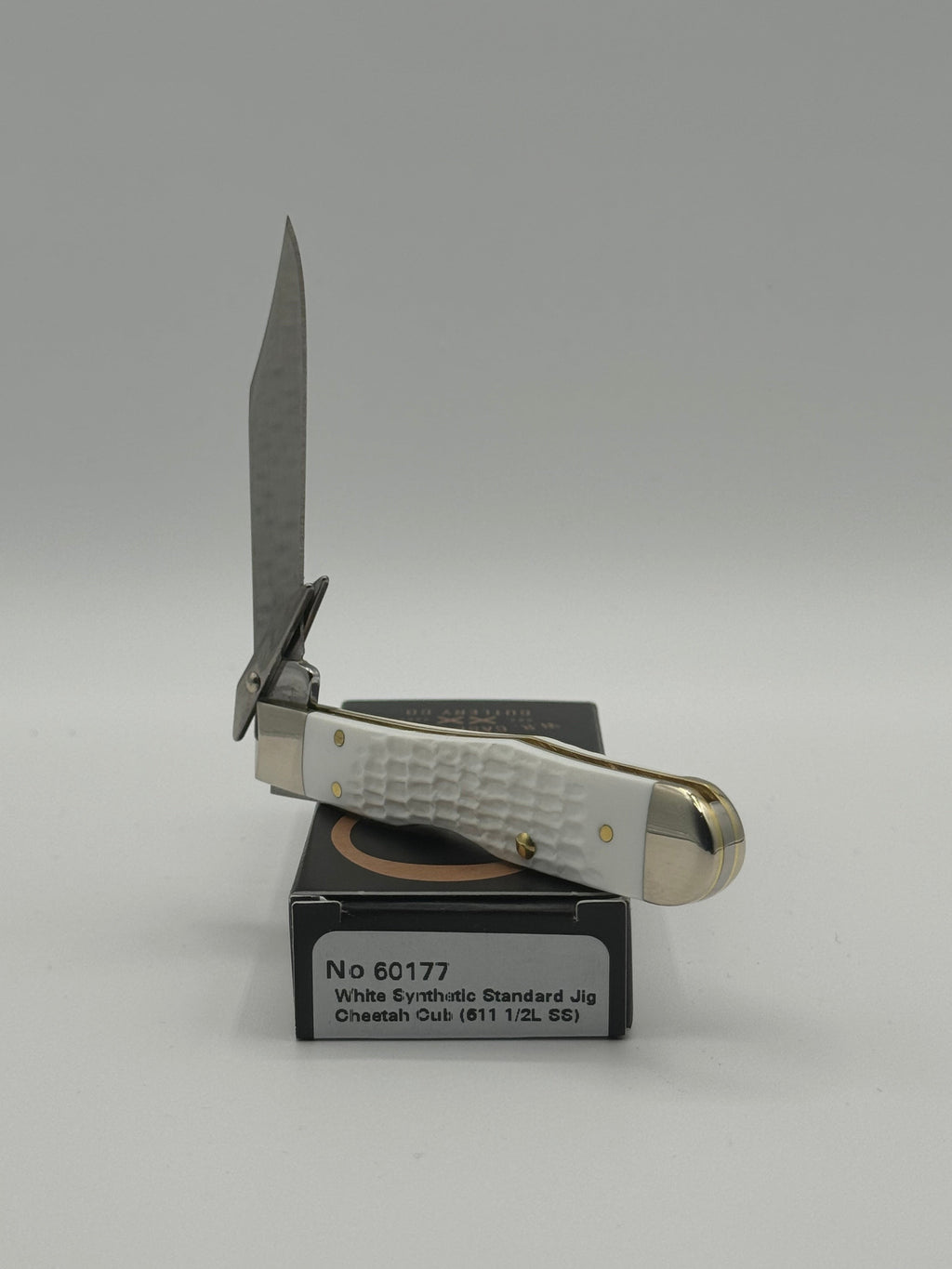 Pigeon Roost Knives Case XX SparXX Cheetah Cub pocket knife with white jigged synthetic handle and locking clip blade.