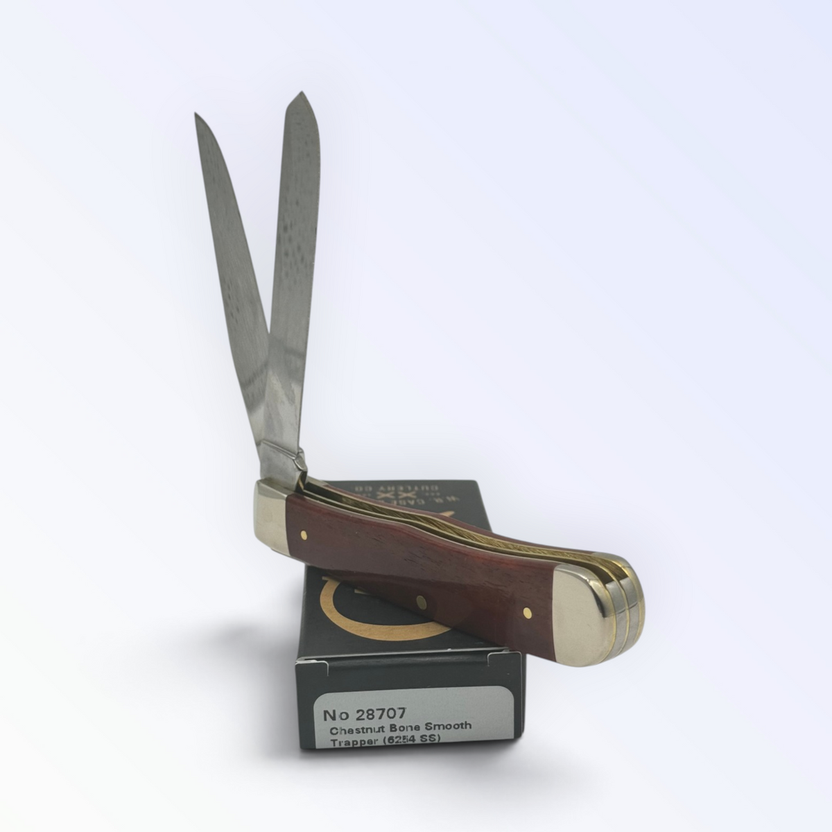 Catalog 28707 Case XX Chestnut Bone Trapper — open blades resting on factory packaging