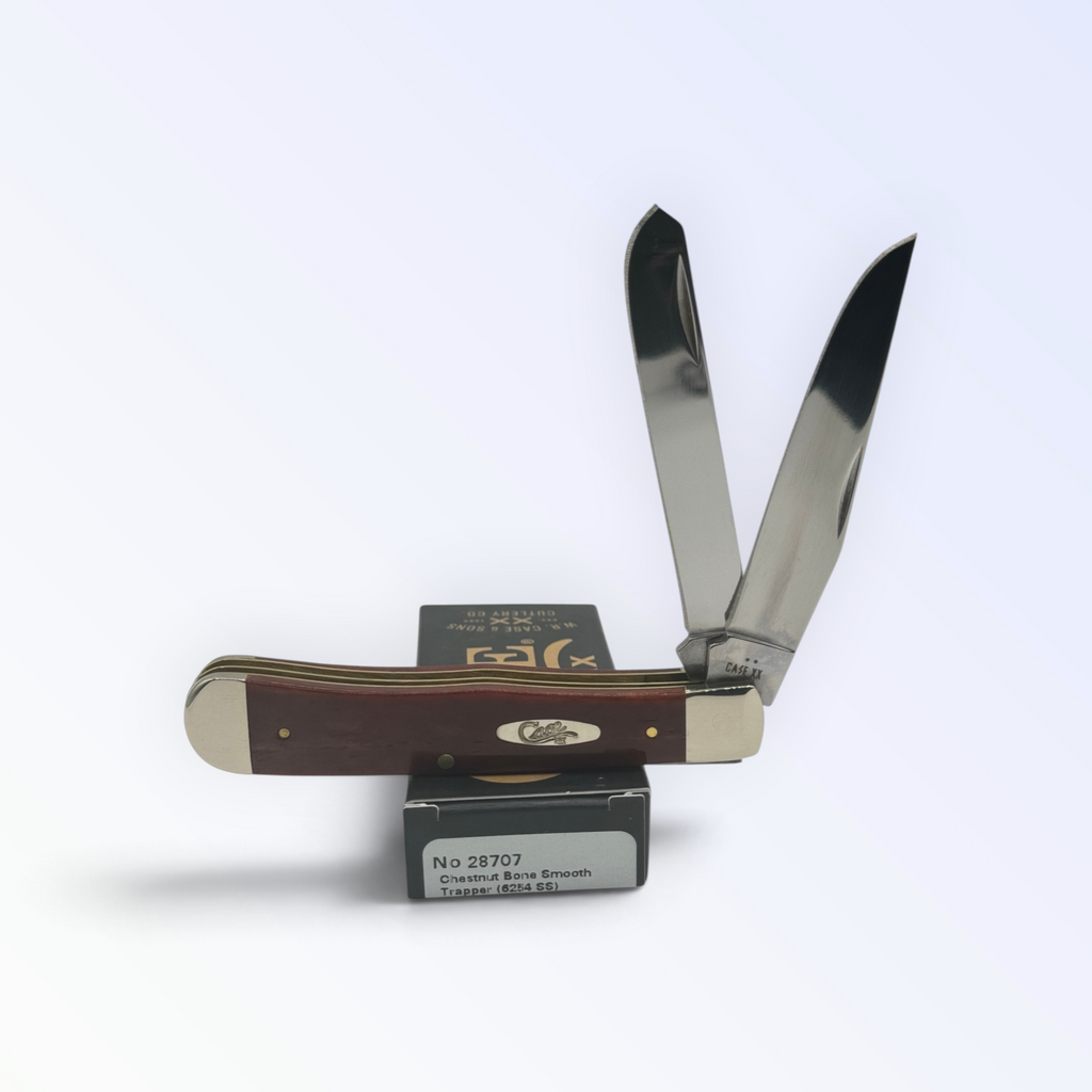 Case XX Chestnut Bone Trapper with SKU 28707 — blades open resting on the factory box