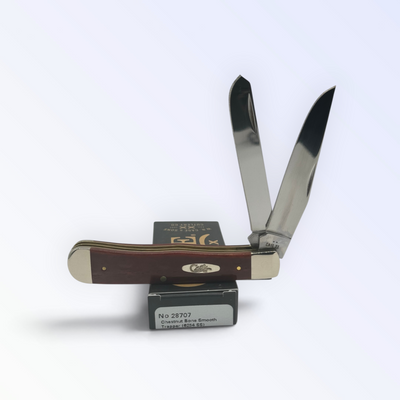 Case XX Chestnut Bone Trapper with SKU 28707 — blades open resting on the factory box