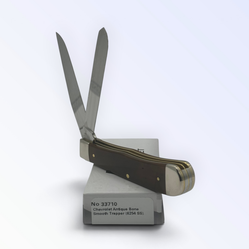 Catalog 33710 Case XX Chevrolet Embellished Antique Bone Trapper — open blades resting on factory packaging