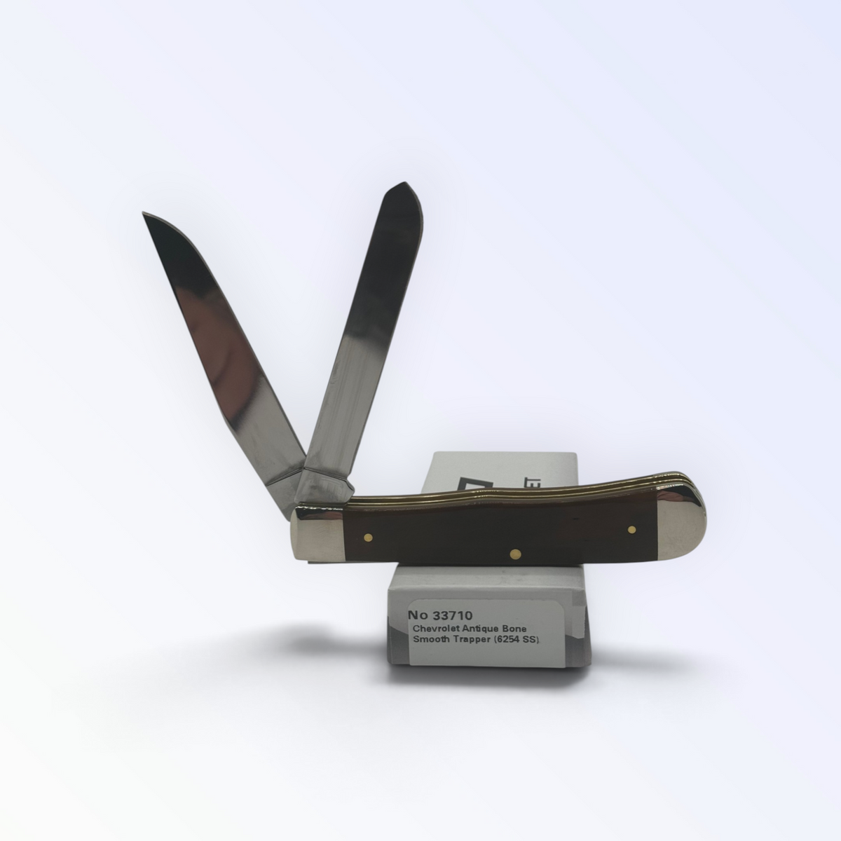 Chevrolet Embellished Antique Bone Trapper by Case XX (33710), close view of handle texture with blades open on box