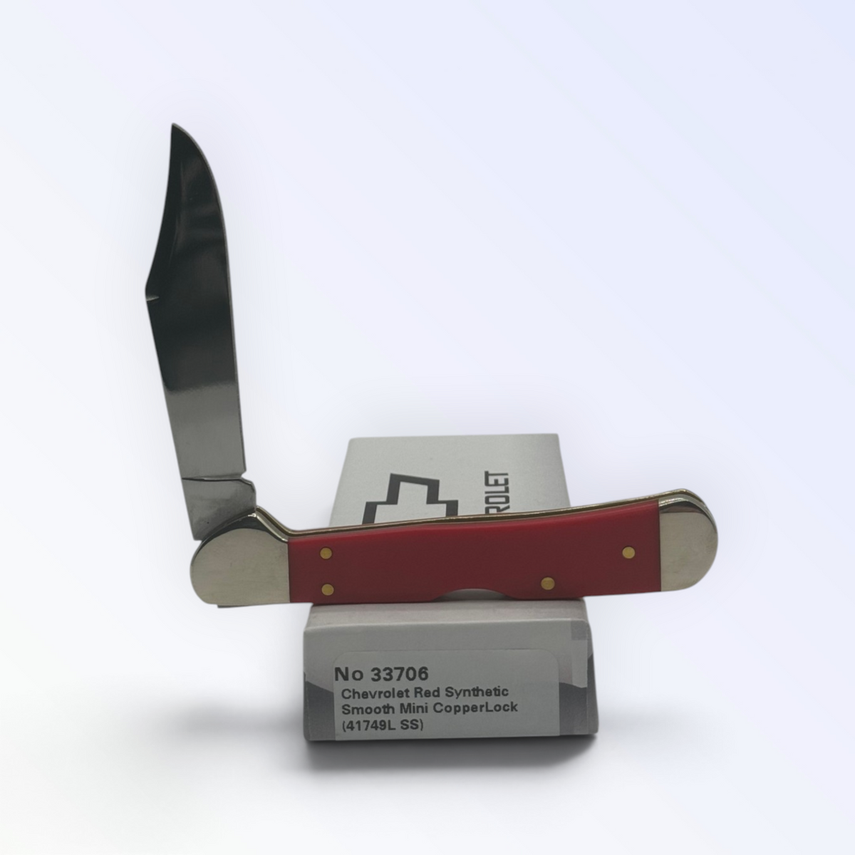 Chevrolet Red Synthetic Mini Copperlock by Case XX (33706), close view of handle texture with blades open on box