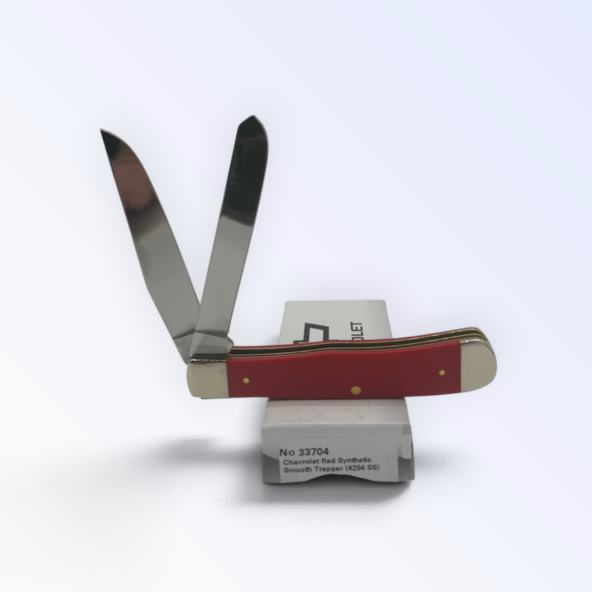 Chevrolet Red Synthetic Trapper by Case XX (33704), close view of handle texture with blades open on box