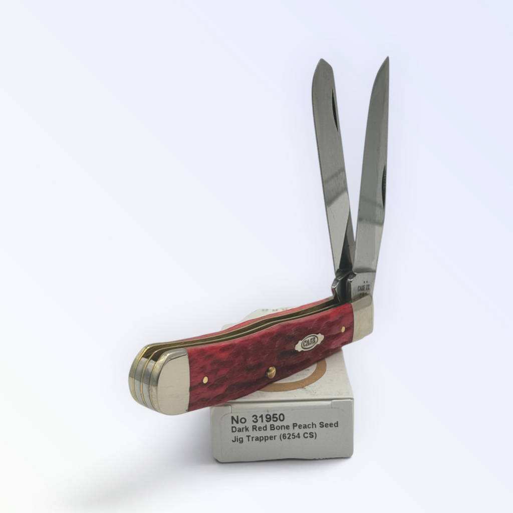 Case XX 31950 – Dark Red Bone Peach Seed Jig Trapper — angled open view on Case XX packaging
