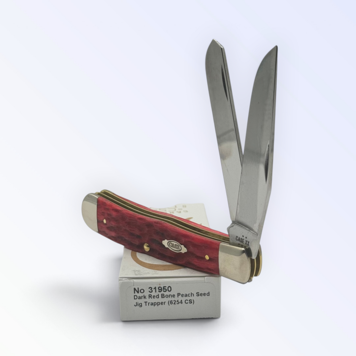 Case XX – Dark Red Bone Peach Seed Jig Trapper, SKU 31950 — closed profile on the Case XX box
