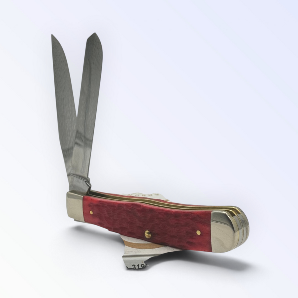 Catalog 31950 Case XX – Dark Red Bone Peach Seed Jig Trapper — open blades resting on factory packaging