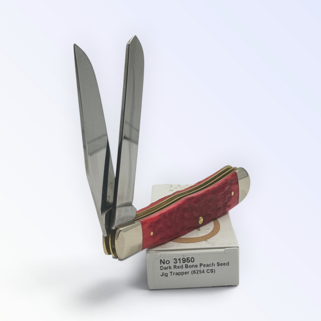 Case XX – Dark Red Bone Peach Seed Jig Trapper (31950) — pocket-knife studio shot on retail box
