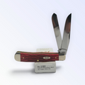 Case XX – Dark Red Bone Peach Seed Jig Trapper with SKU 31950 — blades open resting on the factory box