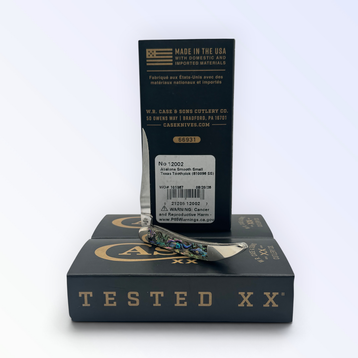 Catalog 12002 Case XX Genuine Abalone Tiny Toothpick — open blades resting on factory packaging