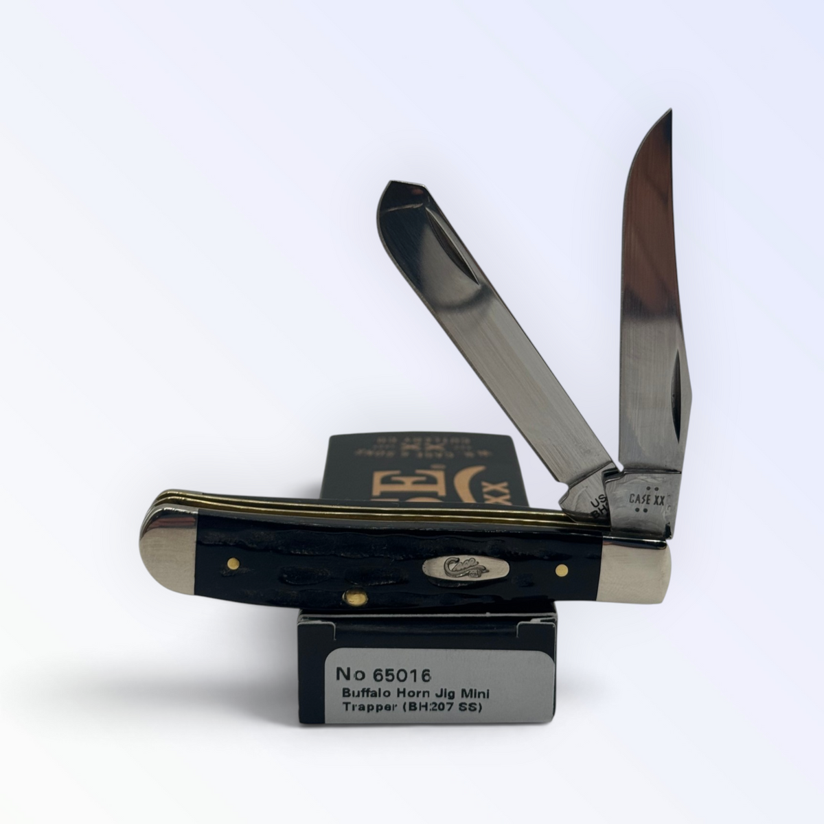 Case XX Jigged Genuine Buffalo Horn Mini Trapper with SKU 65016 — blades open resting on the factory box