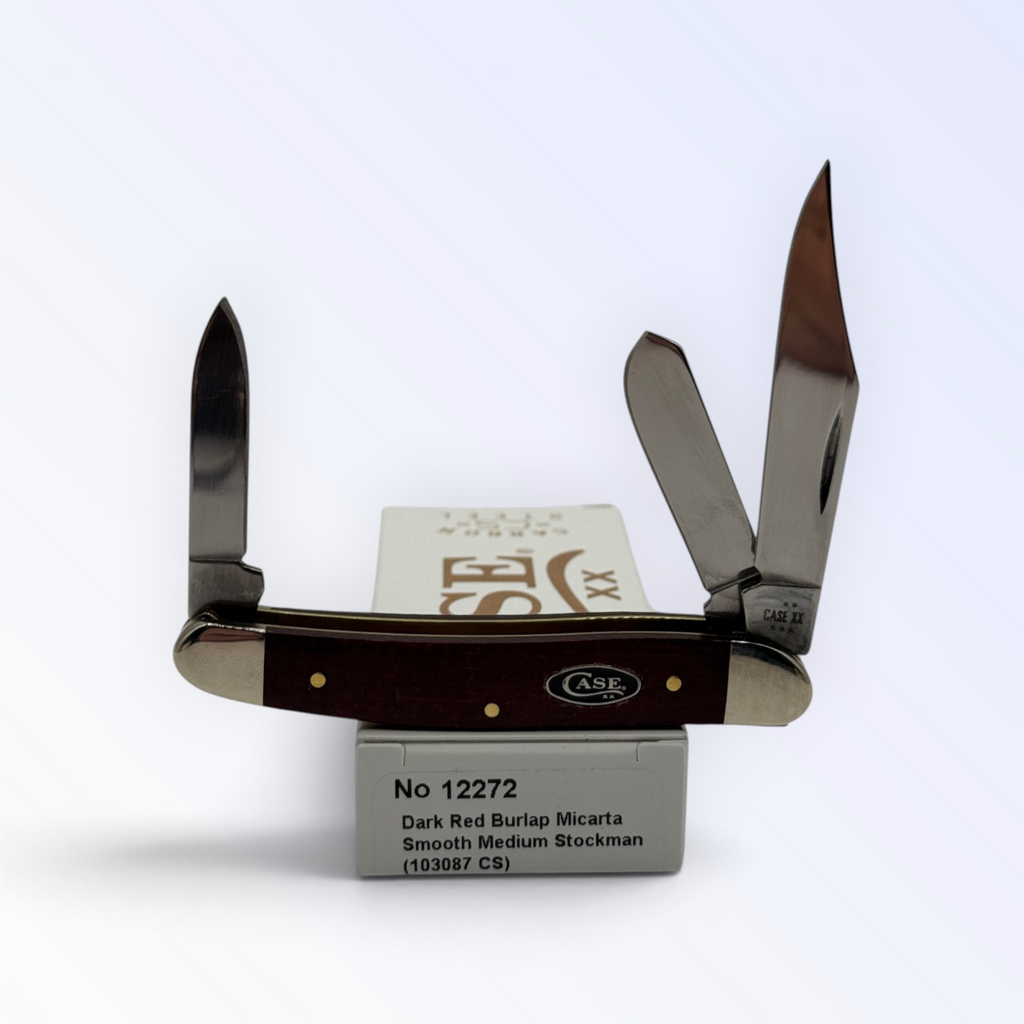 Case XX Medium Stockman with dark red burlap Micarta and 1095 carbon stockman blades, SKU 12272 — blades open resting on the factory box