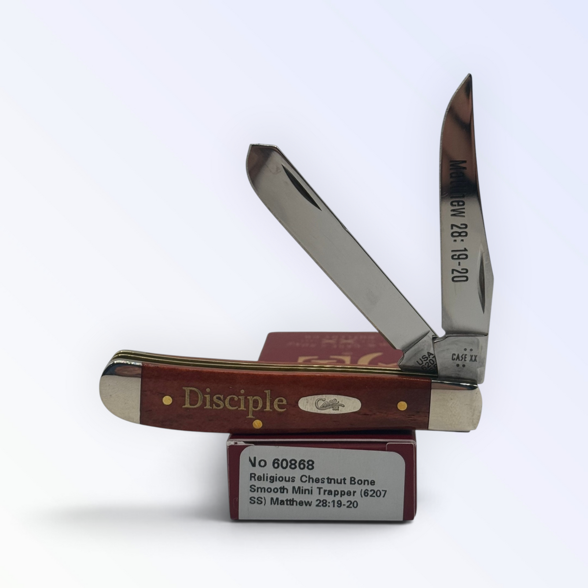 Case XX Mini Trapper 60868: Religious Chestnut Bone Smooth (Matthew 28:19-20), angled view showing handle texture and bolsters