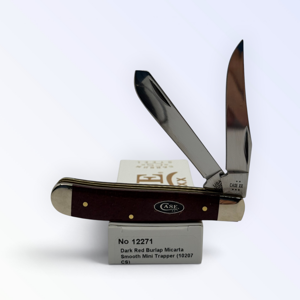 Case XX Mini Trapper with dark red burlap Micarta and 1095 carbon clip and spey, SKU 12271 — blades open resting on the factory box