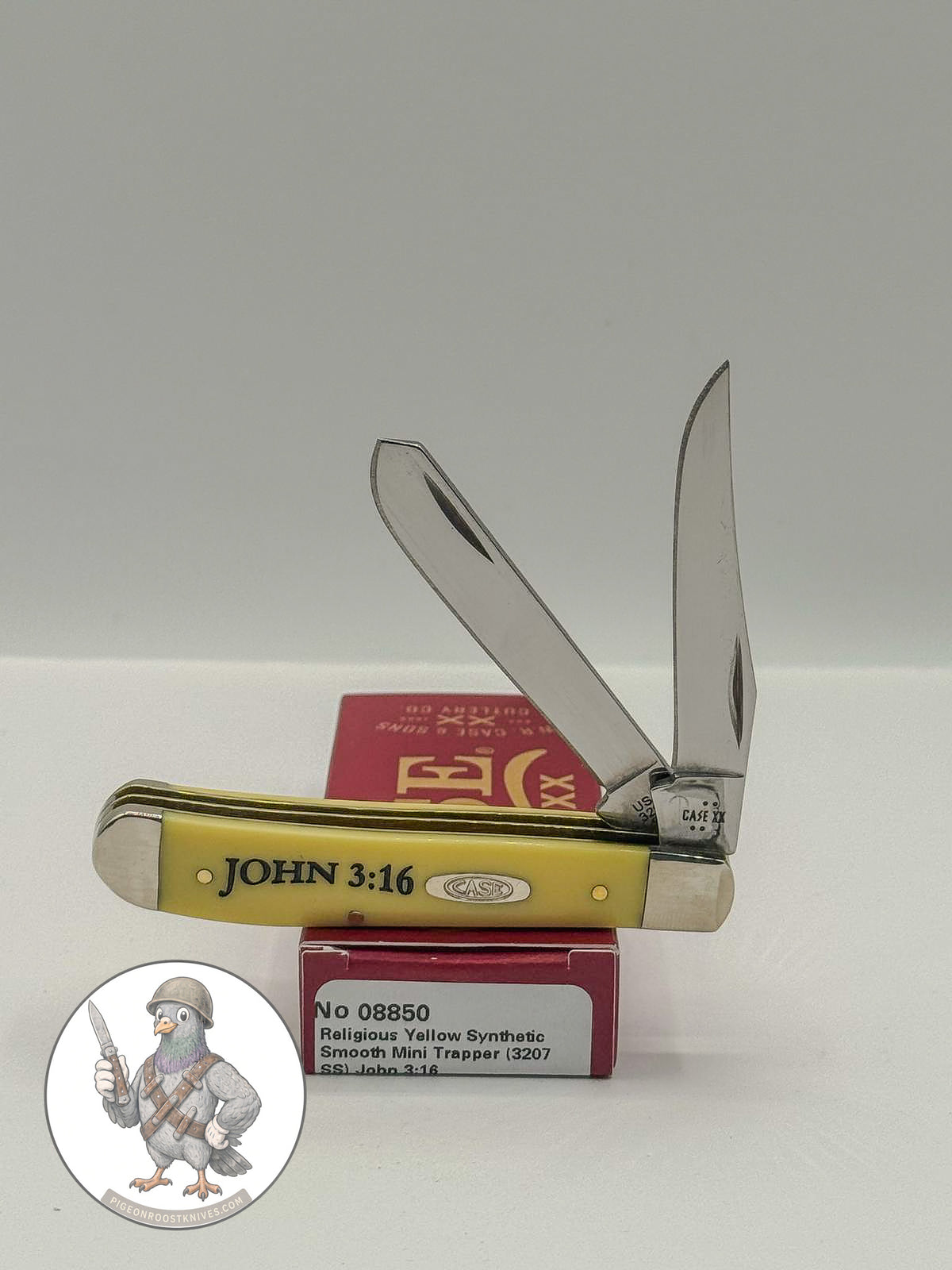 Case XX Mini Trapper with John 3:16 smooth yellow synthetic and religious saying etched blades, SKU 08850 — blades open resting on the factory box