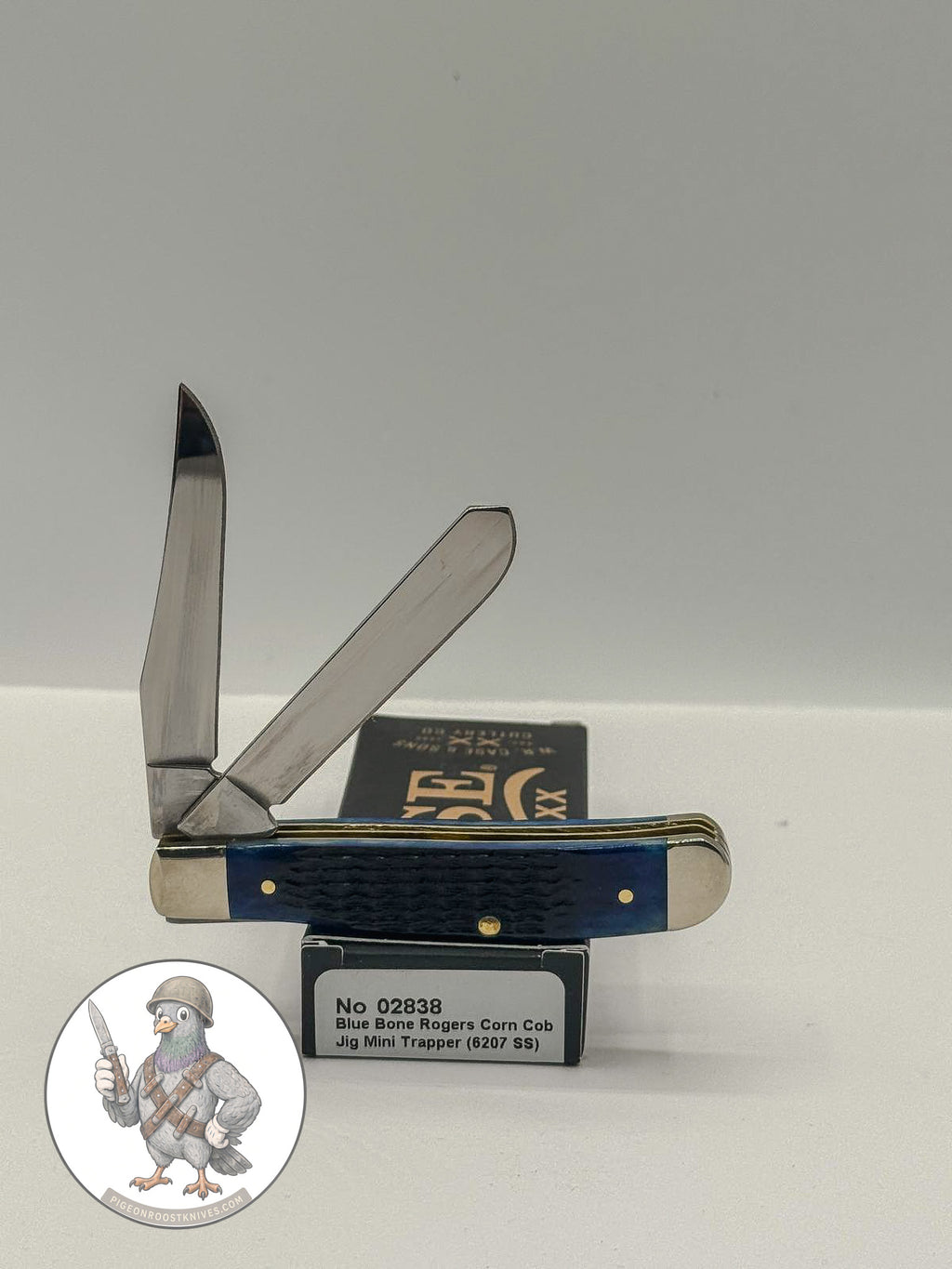 Case XX 02838 Mini Trapper in jigged navy blue bone — angled open view on Case XX packaging