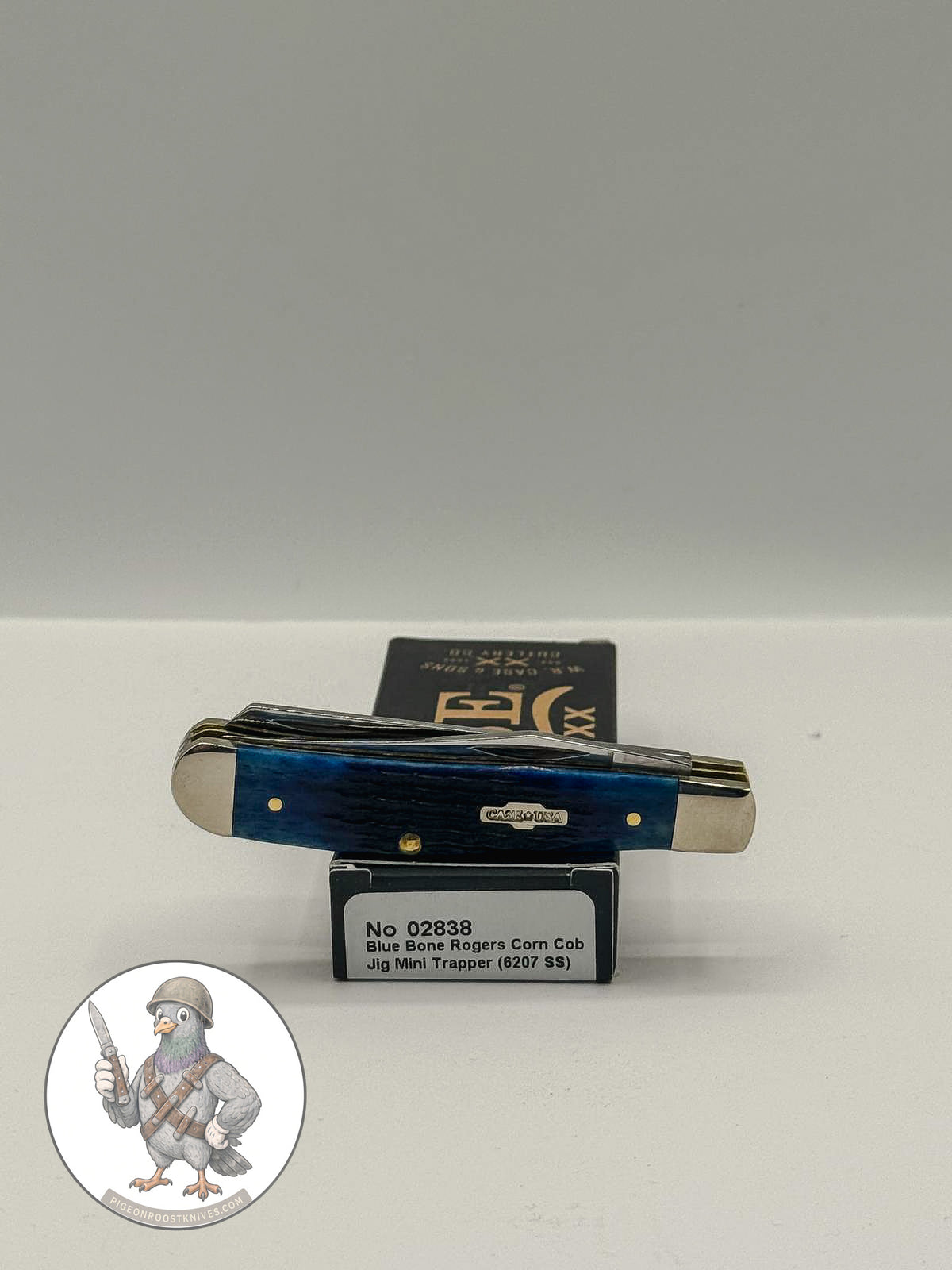 Mini Trapper by Case XX in jigged navy blue bone (02838), open on box with end label facing forward