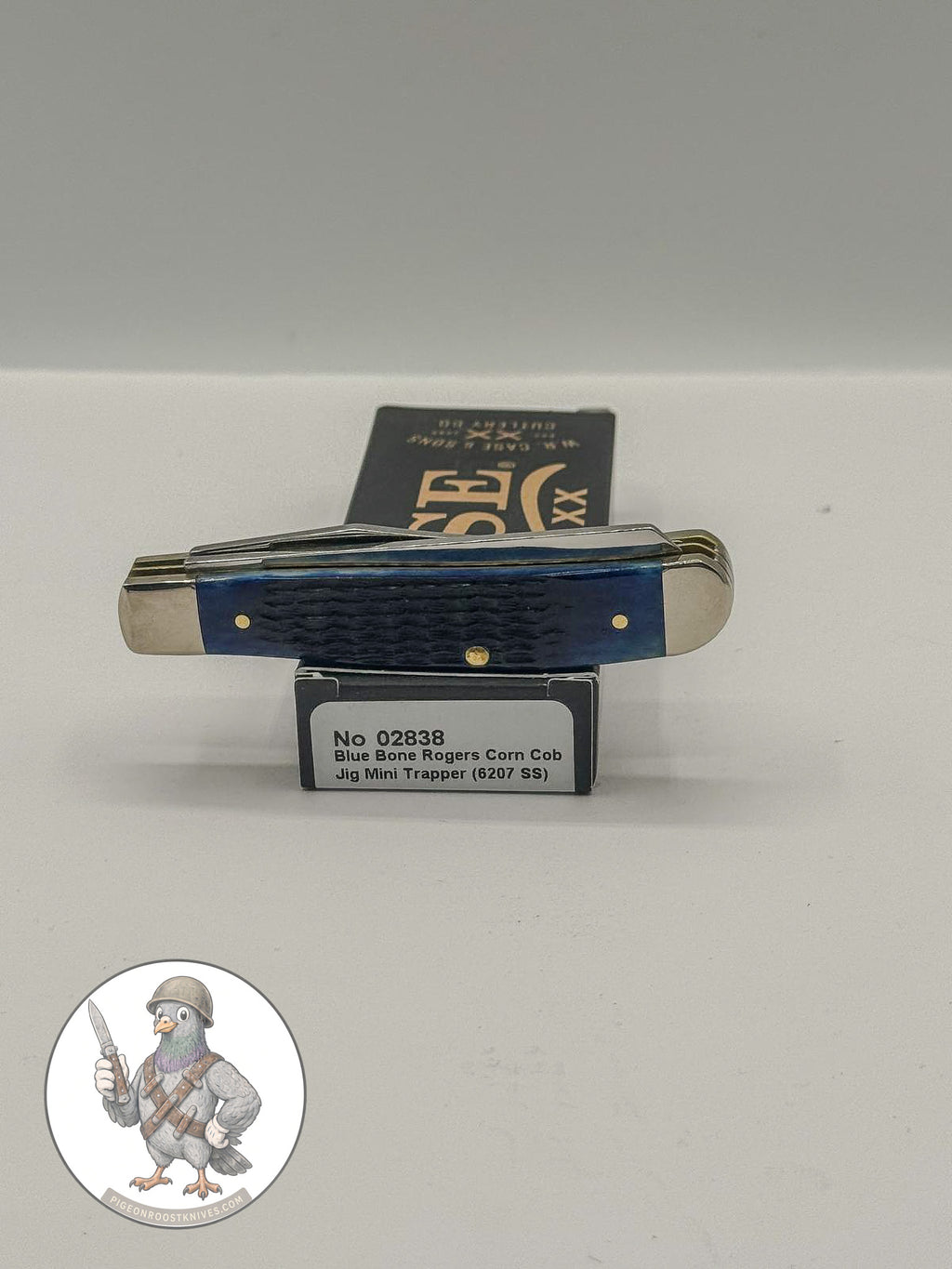 Case XX Mini Trapper 02838: jigged navy blue bone, studio shot open atop the retail box