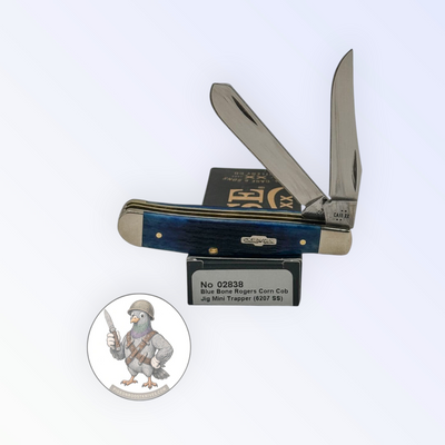 Case XX Mini Trapper with jigged navy blue bone and clip and spey blades, SKU 02838 — blades open resting on the factory box