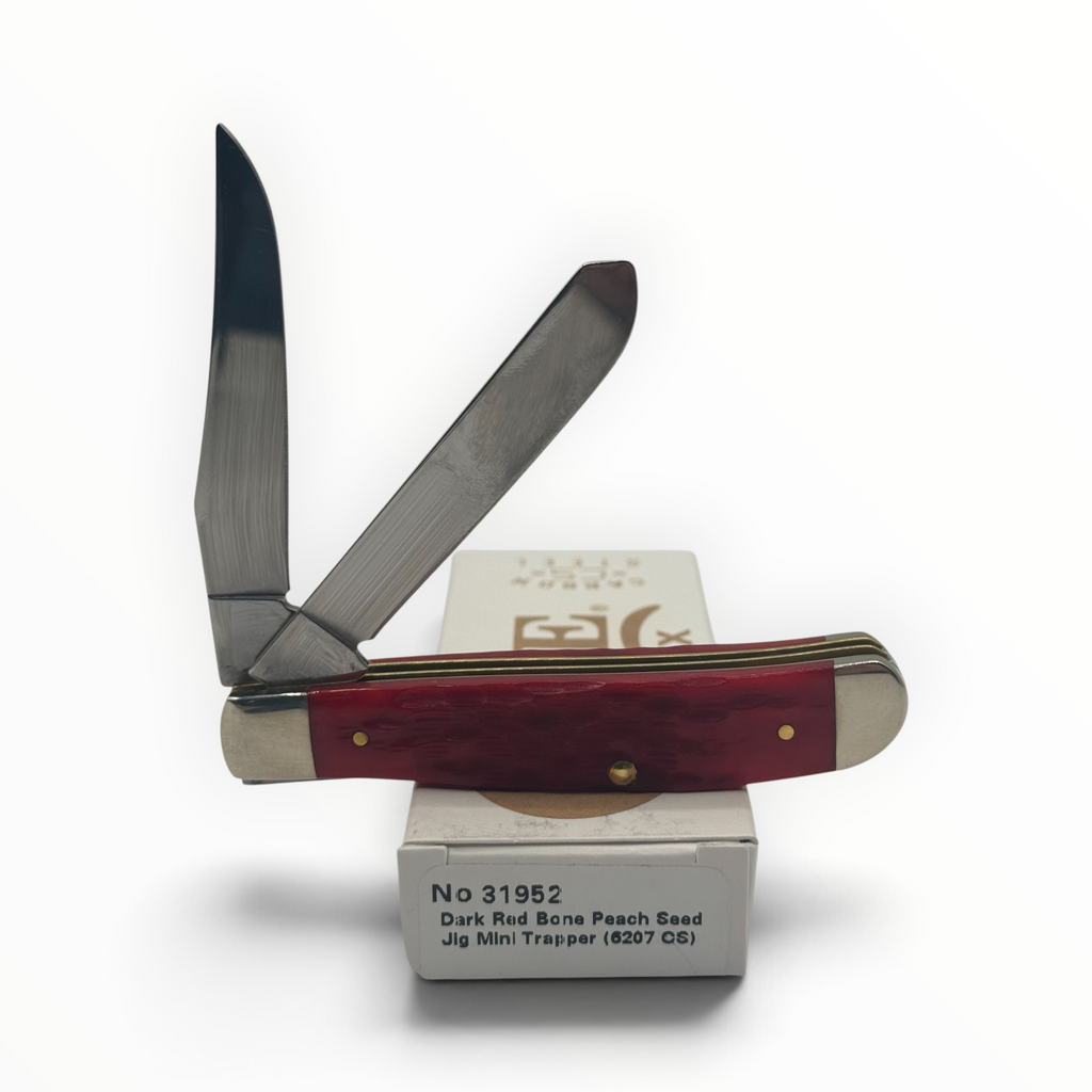 Pigeon Roost Knives Case XX Mini Trapper with dark red peach seed jigged bone handle and two carbon steel blades.