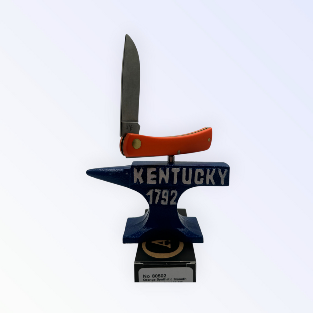 Pigeon Roost Knives Case XX Sod Buster Jr pocket knife with a smooth orange handle displayed on a Kentucky anvil