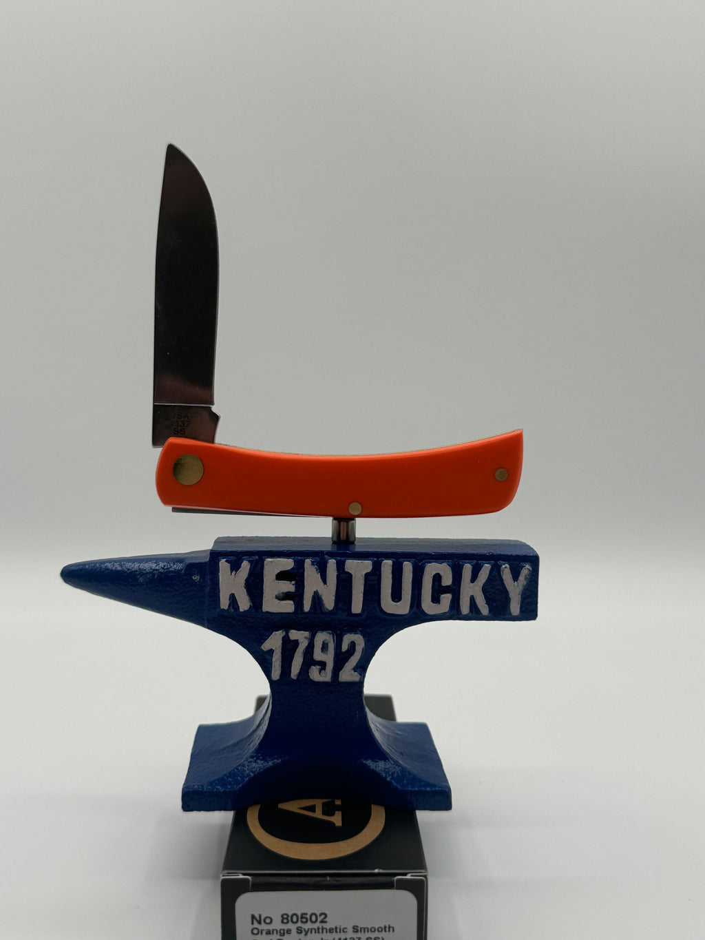 Pigeon Roost Knives Case XX Sod Buster Jr pocket knife with smooth orange handle and Aliens artwork on an anvil stand