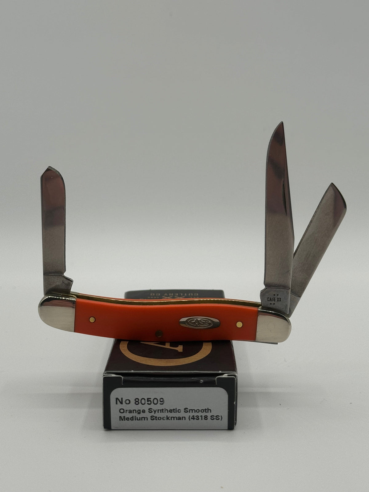 Pigeon Roost Knives Case XX Medium Stockman pocket knife with smooth orange synthetic handle and three steel blades.