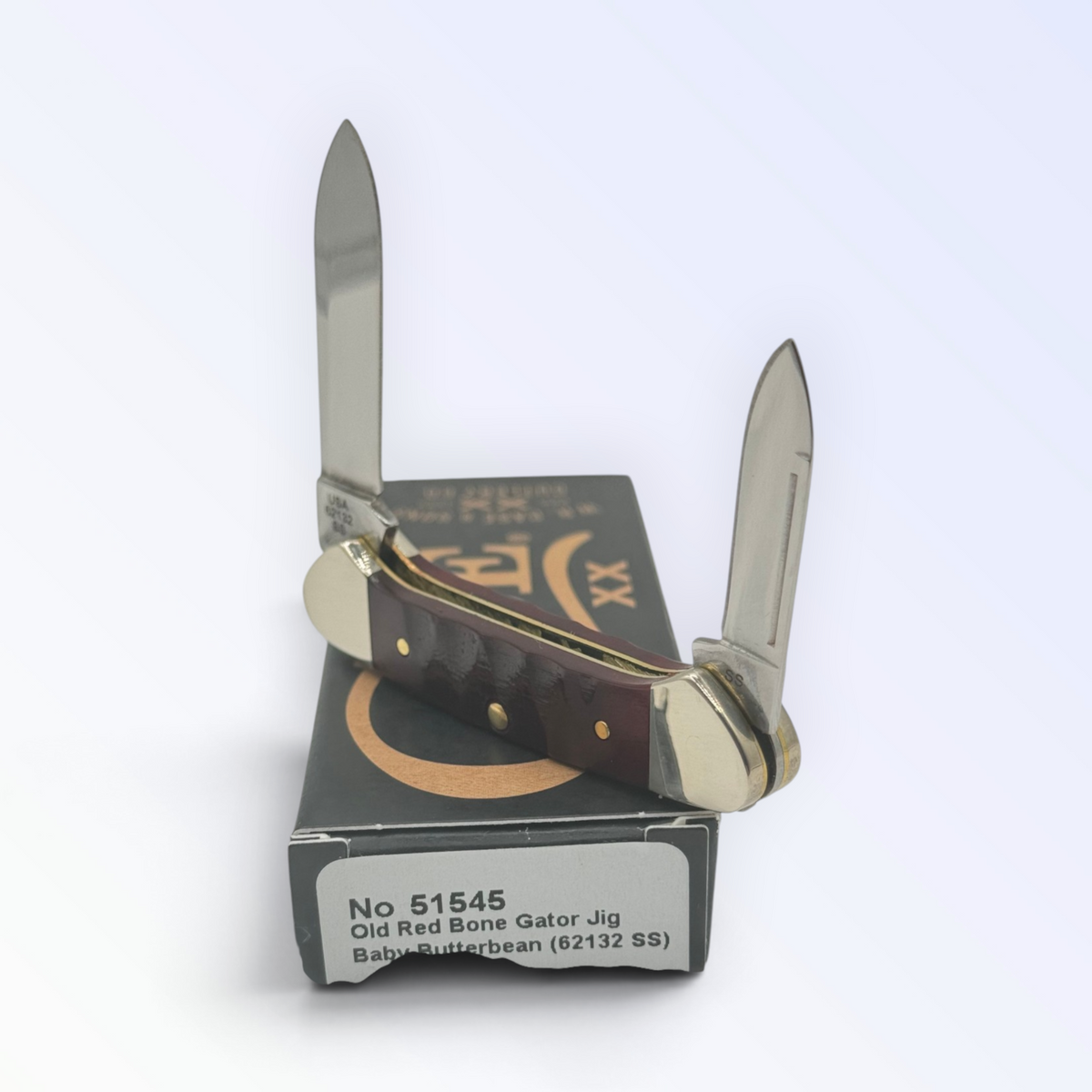 Catalog 51545 Case XX Red Bone Gator Jig Baby Butterbean — open blades resting on factory packaging
