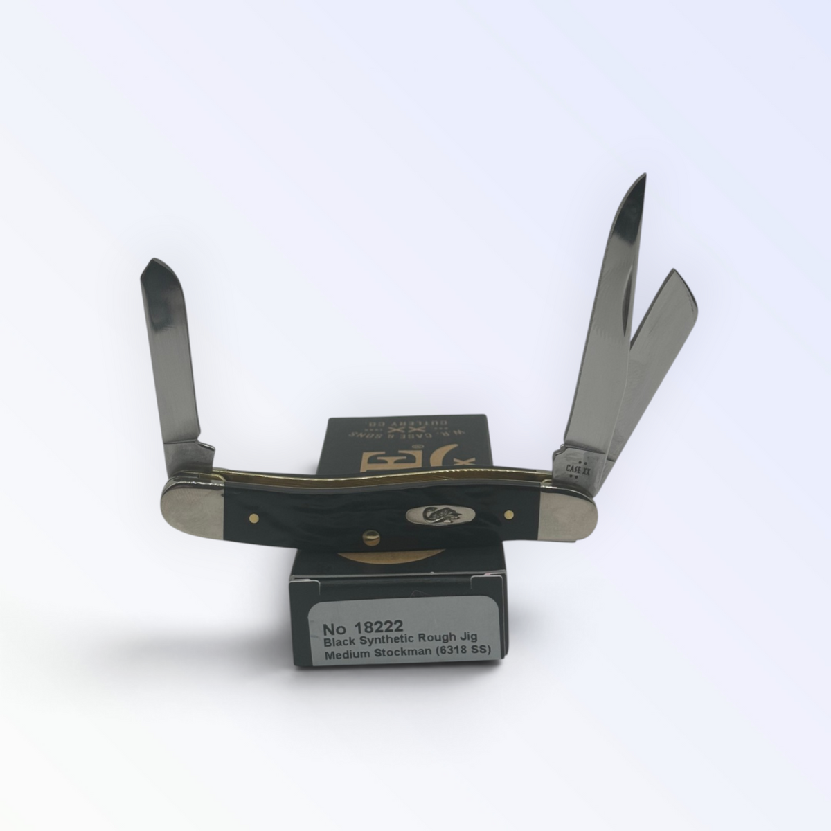 Case XX Rough Black Synthetic Medium Stockman with SKU 18222 — blades open resting on the factory box