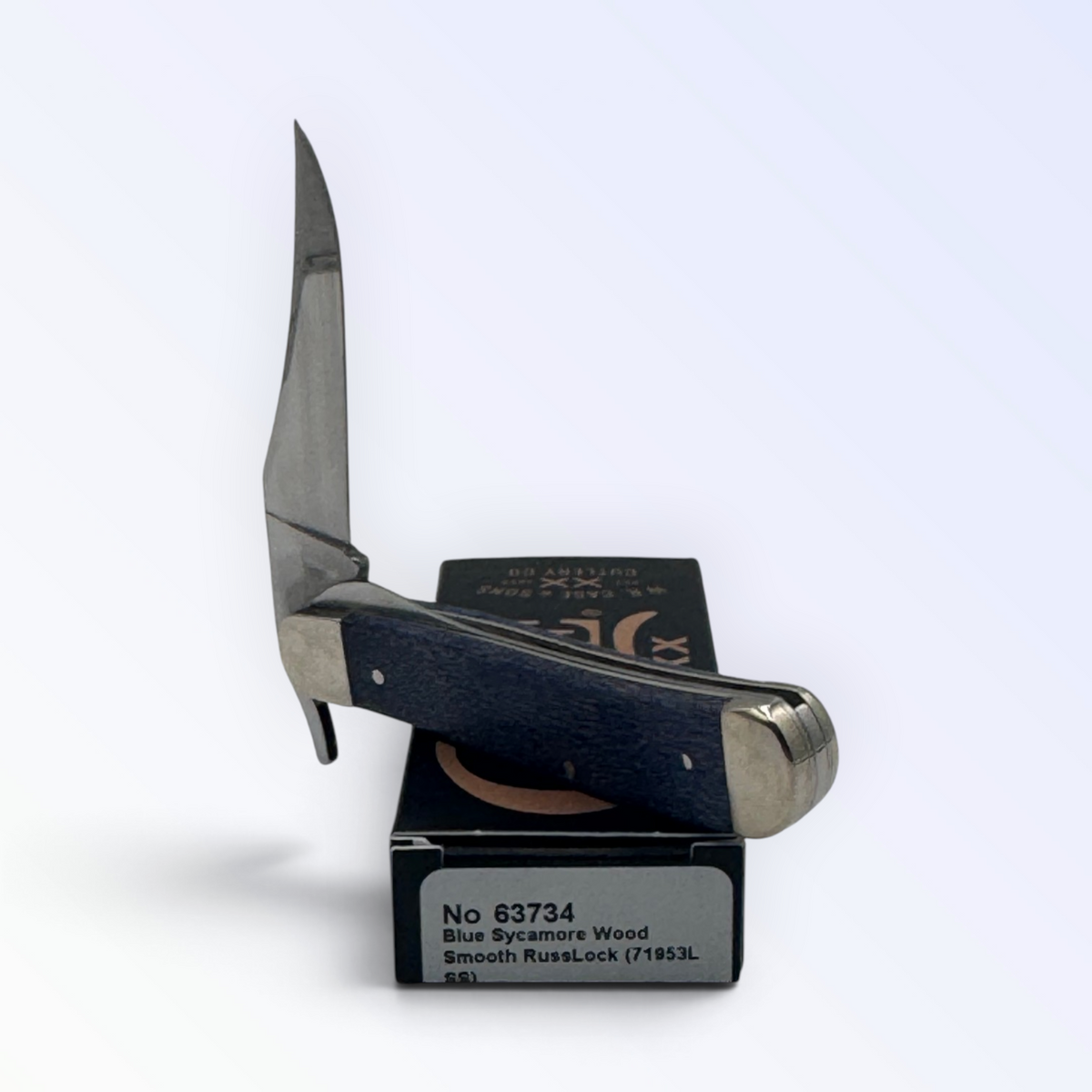 Catalog 63734 Case XX Russlock Smooth Blue Sycamore Wood — open blades resting on factory packaging