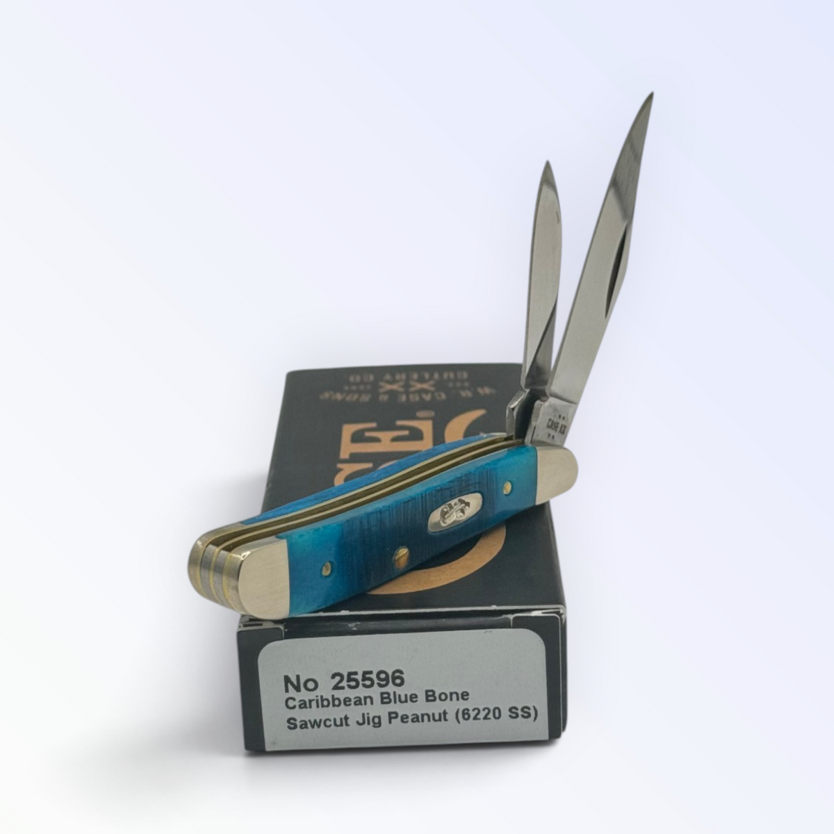 Case XX Sawcut Caribbean Blue Bone Peanut, SKU 25596 — closed profile on the Case XX box